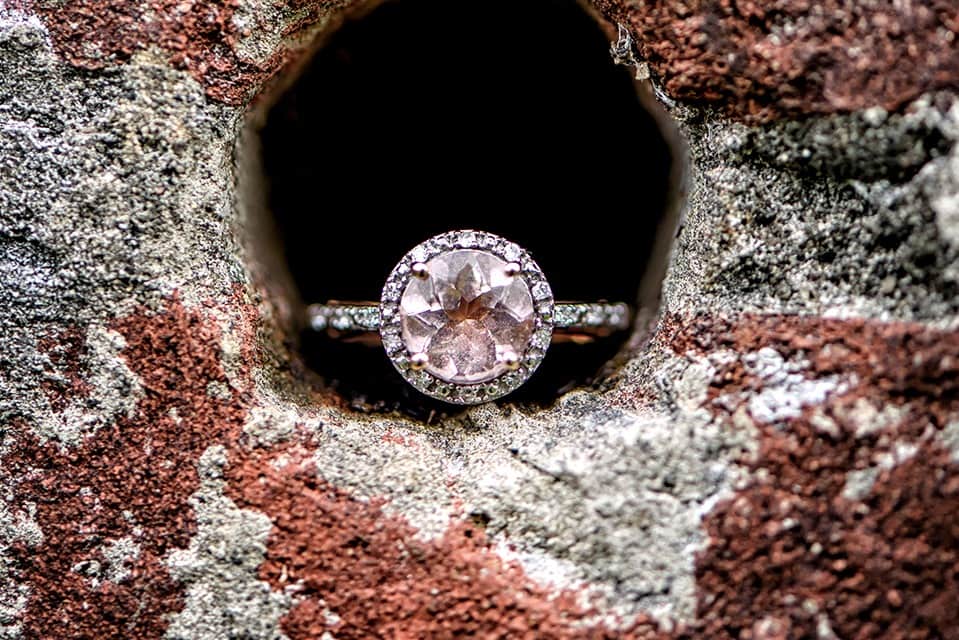 A beautiful pink diamond engagement ring captured in an urban setting at Point Pleasant Park in Halifax.