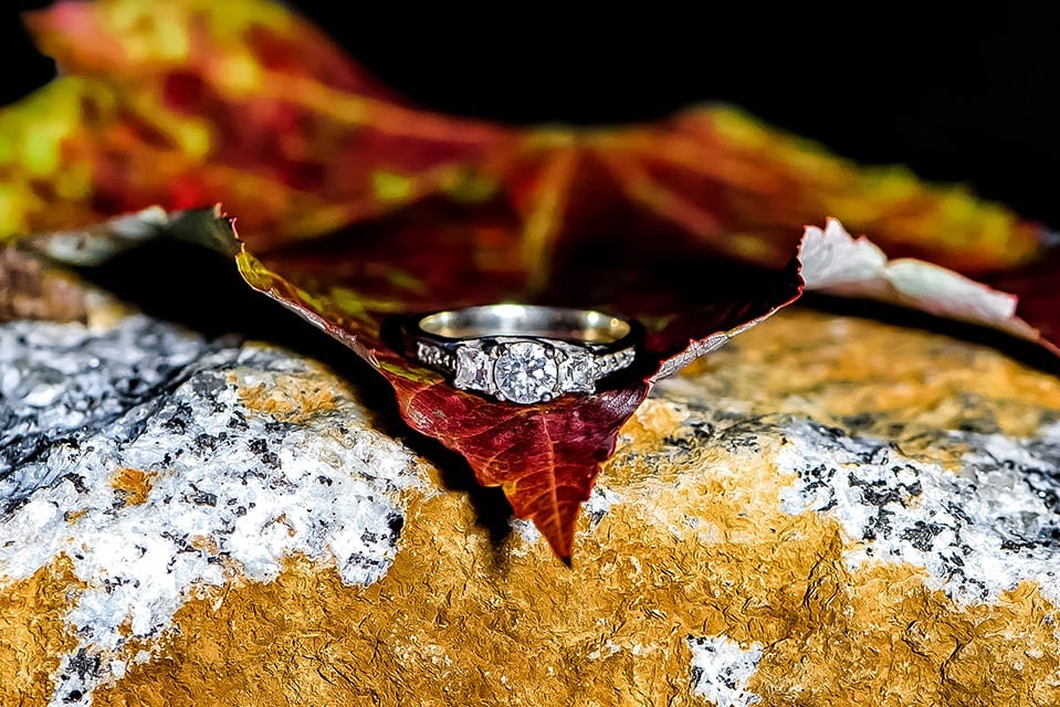 The engagement ring laying on an autumn leaf during an engagement shoot at Point Pleasant Park in Halifax, NS.