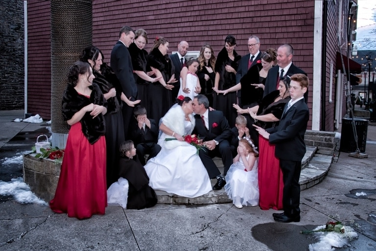 Funny wedding party photos with the bride and groom kissing at the Historic Properties in Halifax, NS.
