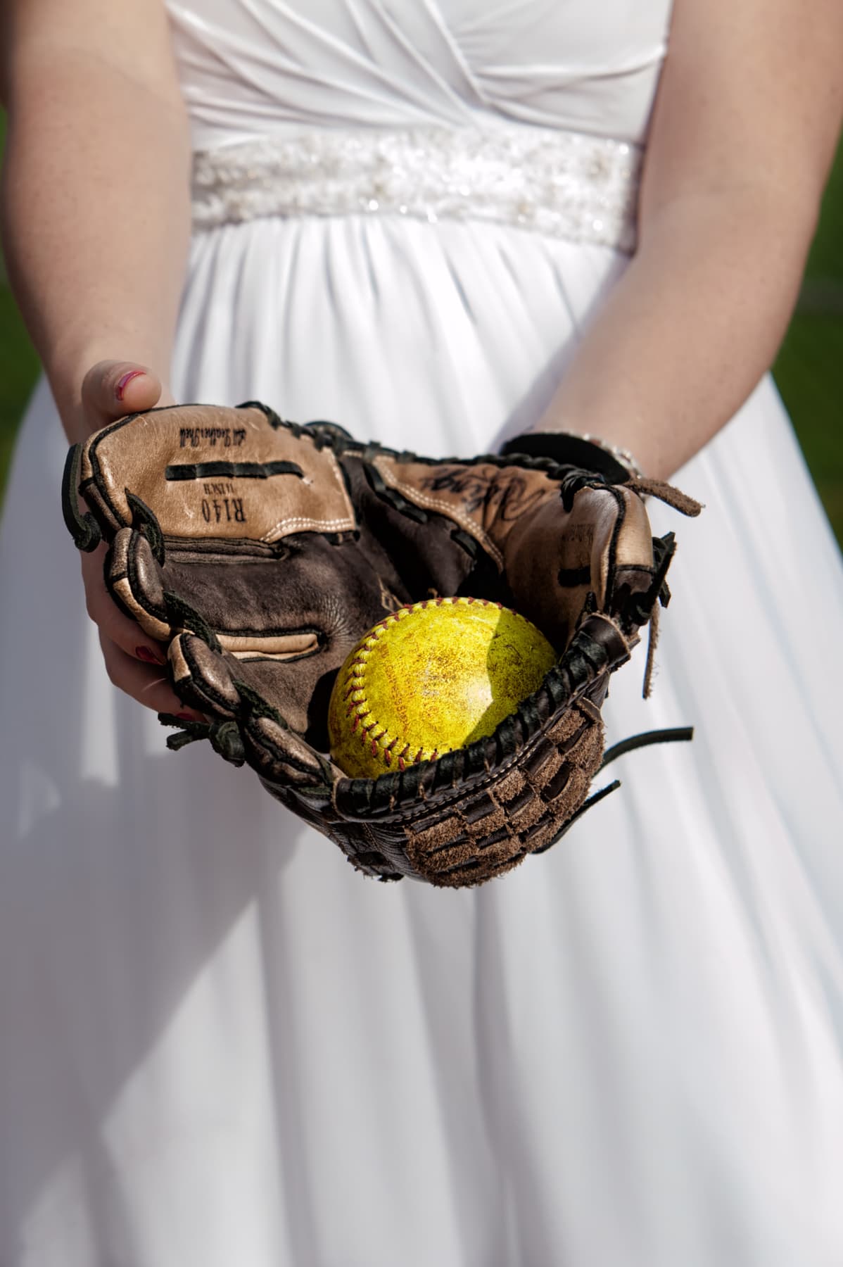 Bride with baseball and mit for a trash the dress photoshoot in Dartmouth NS.