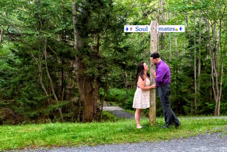 A cute couple in love stare at each other during their engagement photos at Sir Sandford Fleming Park in Halifax, NS.