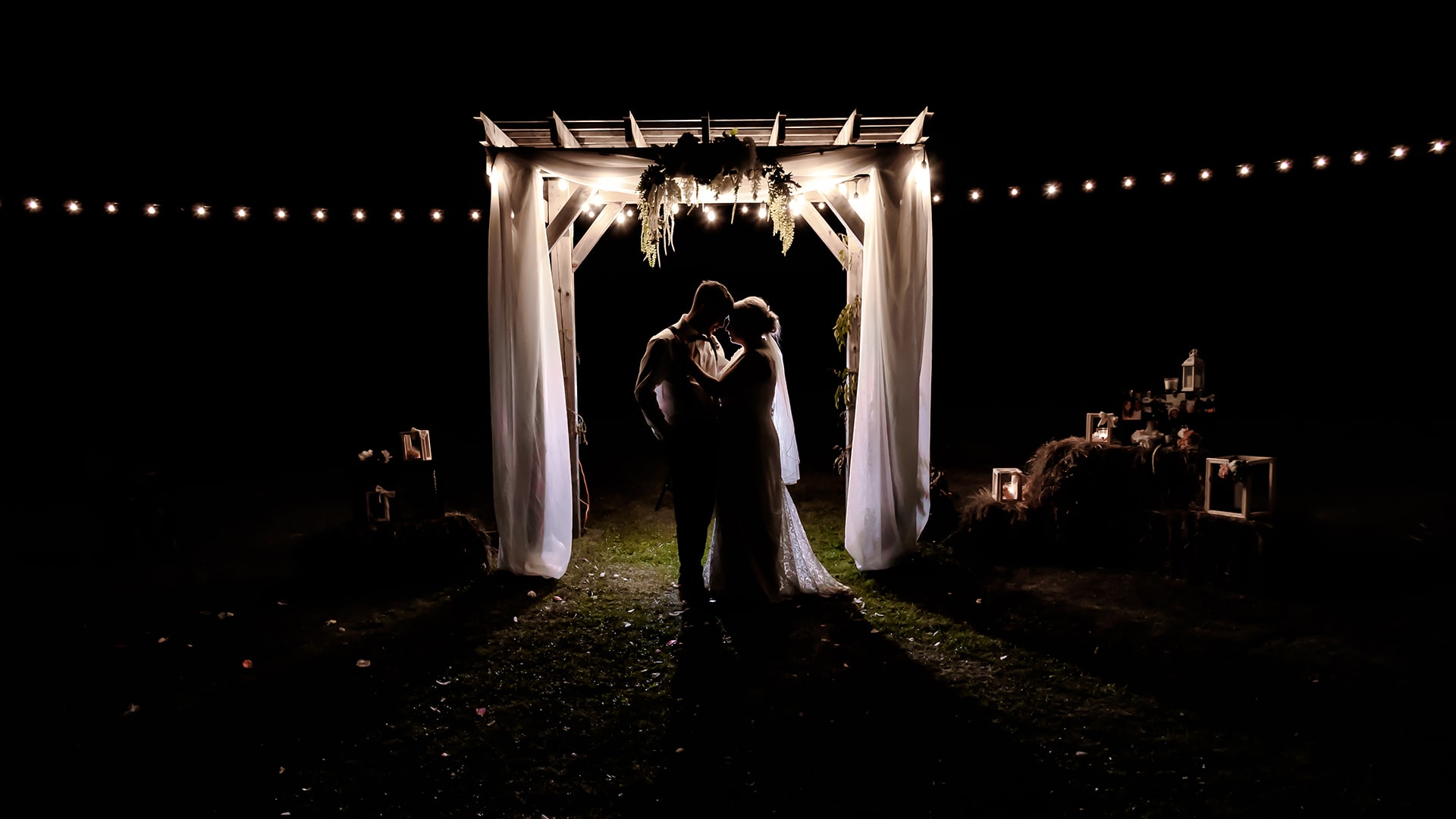 Bride and groom in silhouette, night wedding photos under a trellis at the barn at Sadie Belle Farm in Nova Scotia.