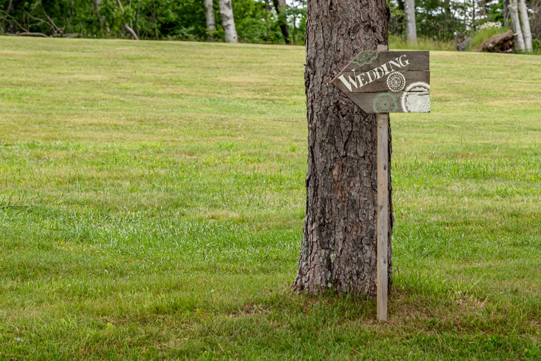 A wooden wedding sign for a ceremony at the Founders House in Annapolis Royal NS.