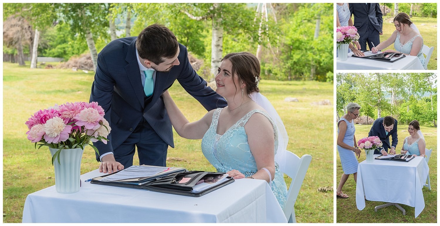 The bride and groom sign their marriage certificate during their wedding ceremony at the Founders House in Annapolis Royal, NS.