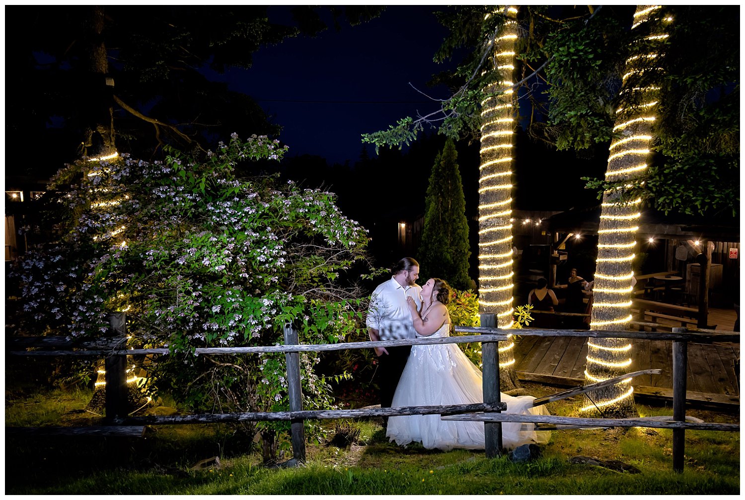 A bride and groom pose after the sun goes down for night wedding photos at Hatfield Farm among the twinkle lit trees.
