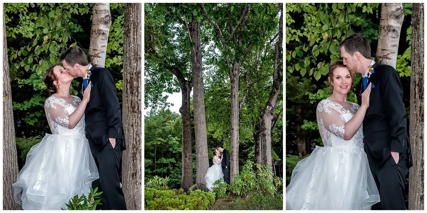 The bride and groom stand between the forest trees for wedding photos at Saraguay House.