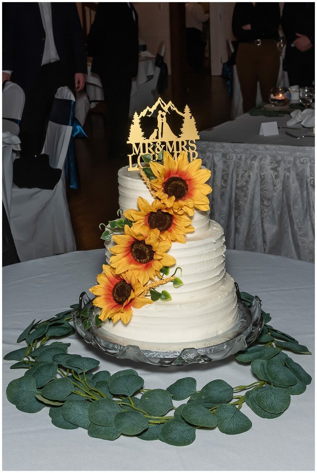 A buttery wedding cake adorned with sunflower decorations.