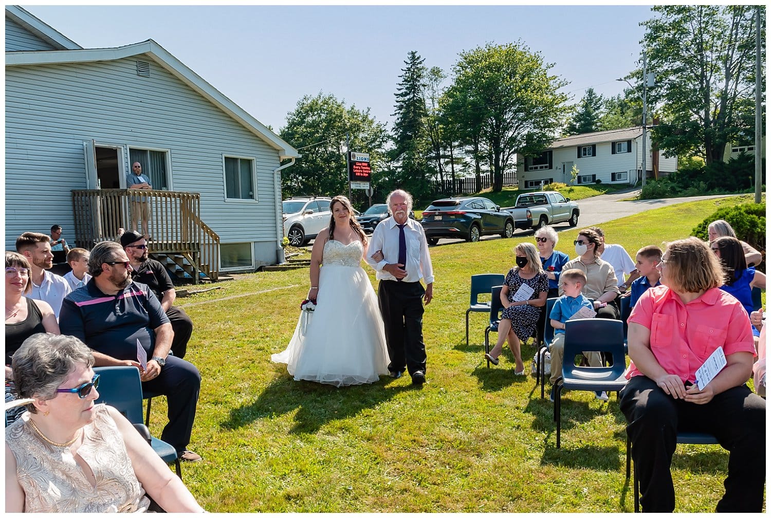 The bride is walked up the aisle by her uncle during her wedding ceremony at the Lower Sackville Lions Club in NS.