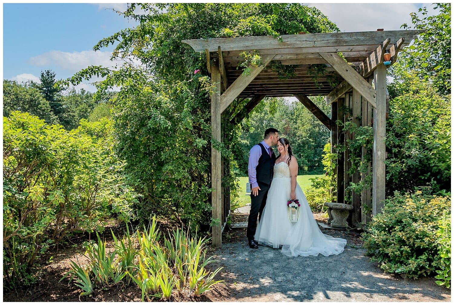 The bride and groom share their first look under a trellis in Acadia Park Lower Sackville NS.