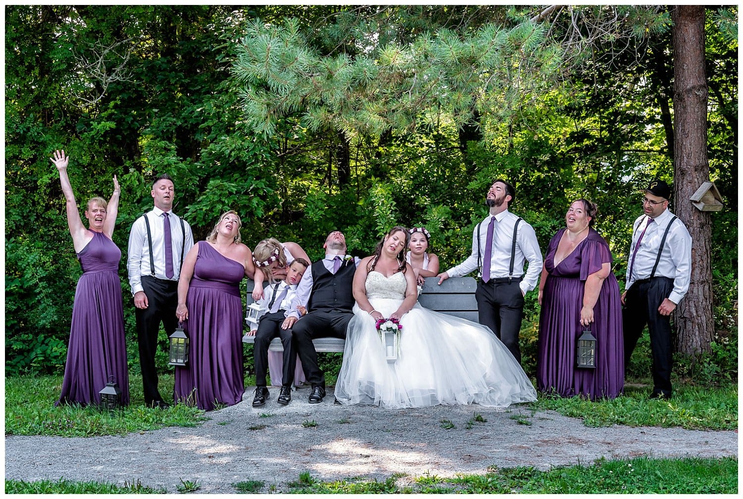 The wedding party pose exhausted in 41 degree weather at Acadia Park in Sackville NS,