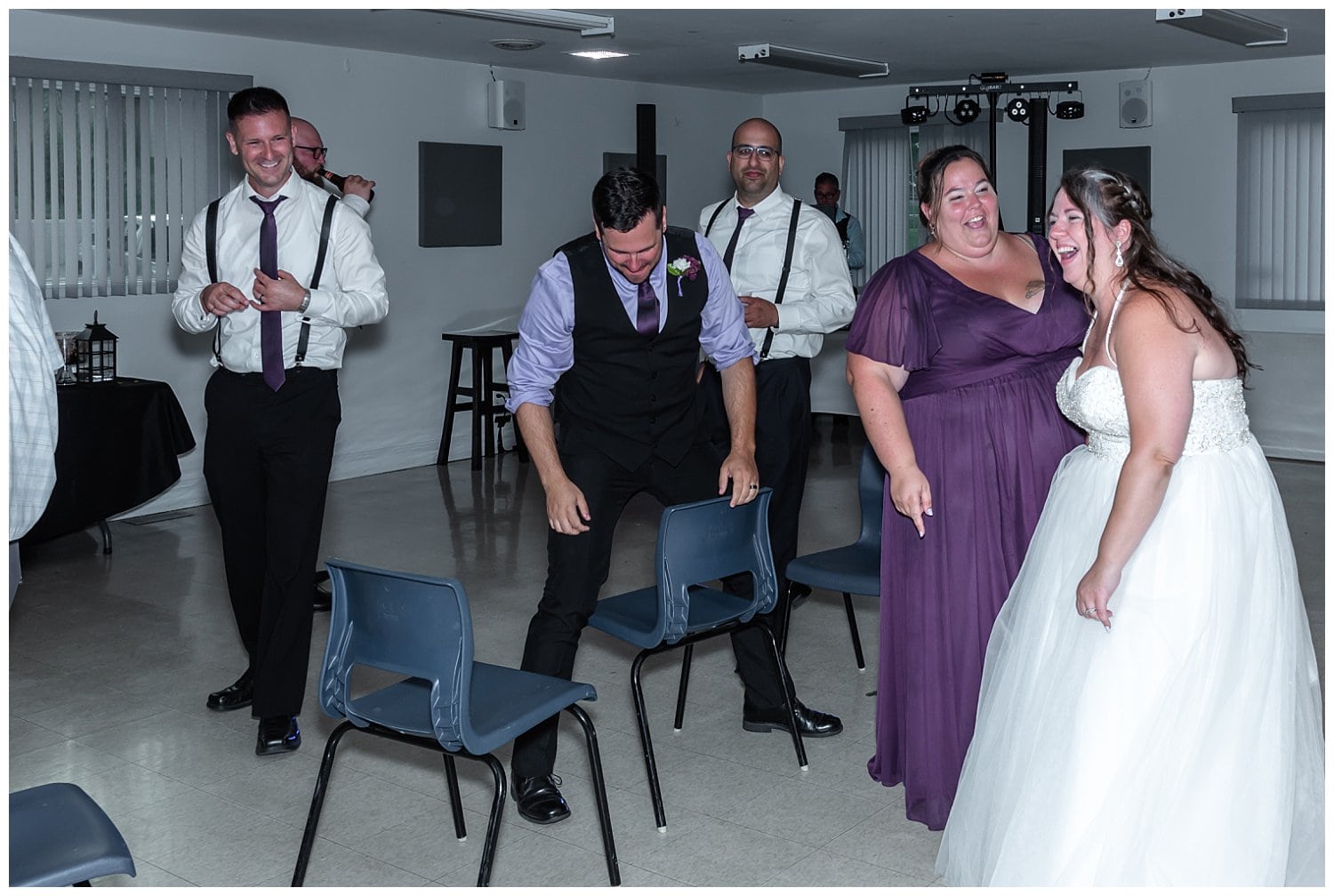 The bride manages to pick out the groom after playing the elbow and knee game at their wedding reception.