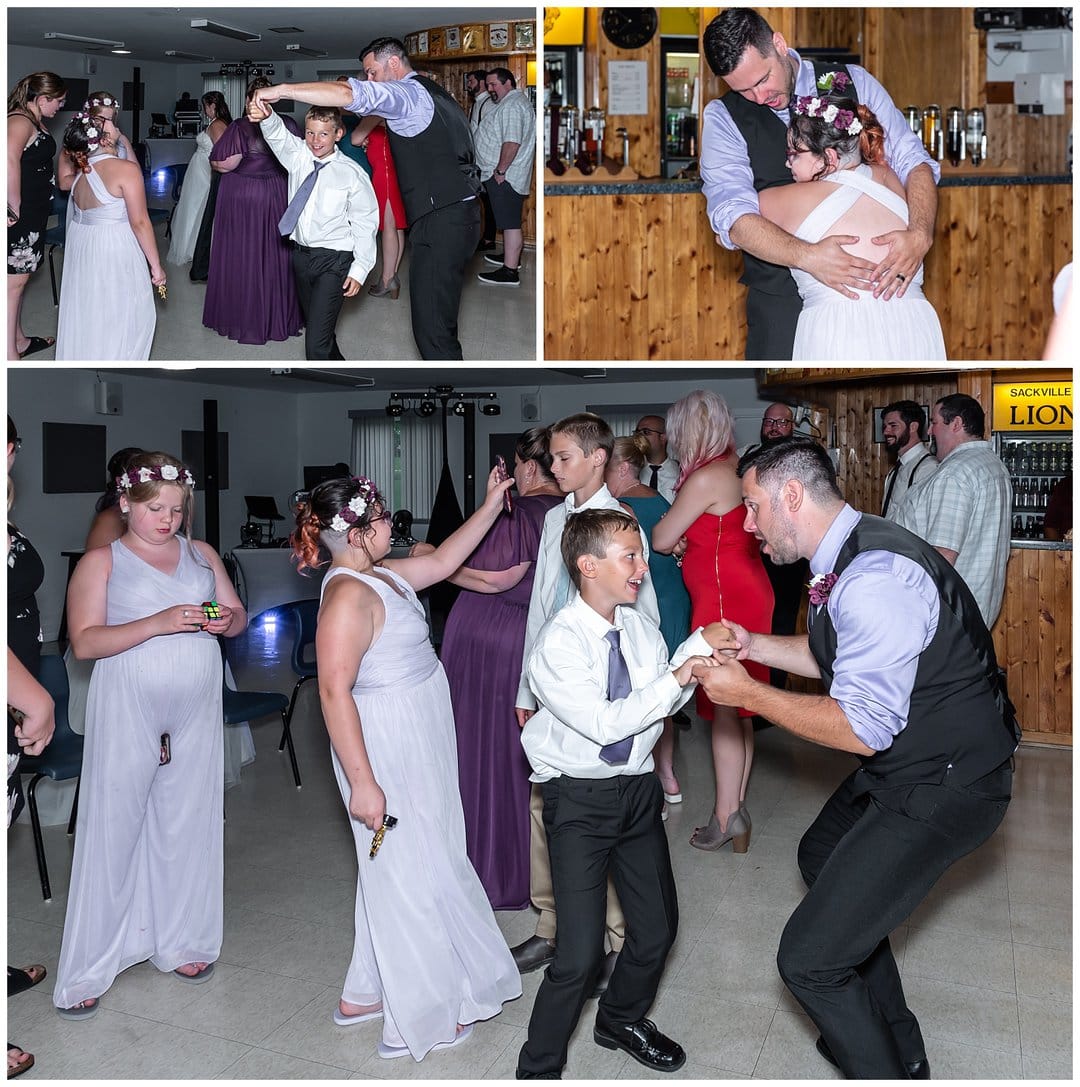 The groom dances with his son on the dance floor during the wedding reception.