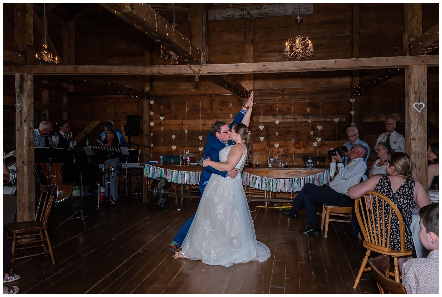 The groom dips his bride during their first dance at their wedding reception.