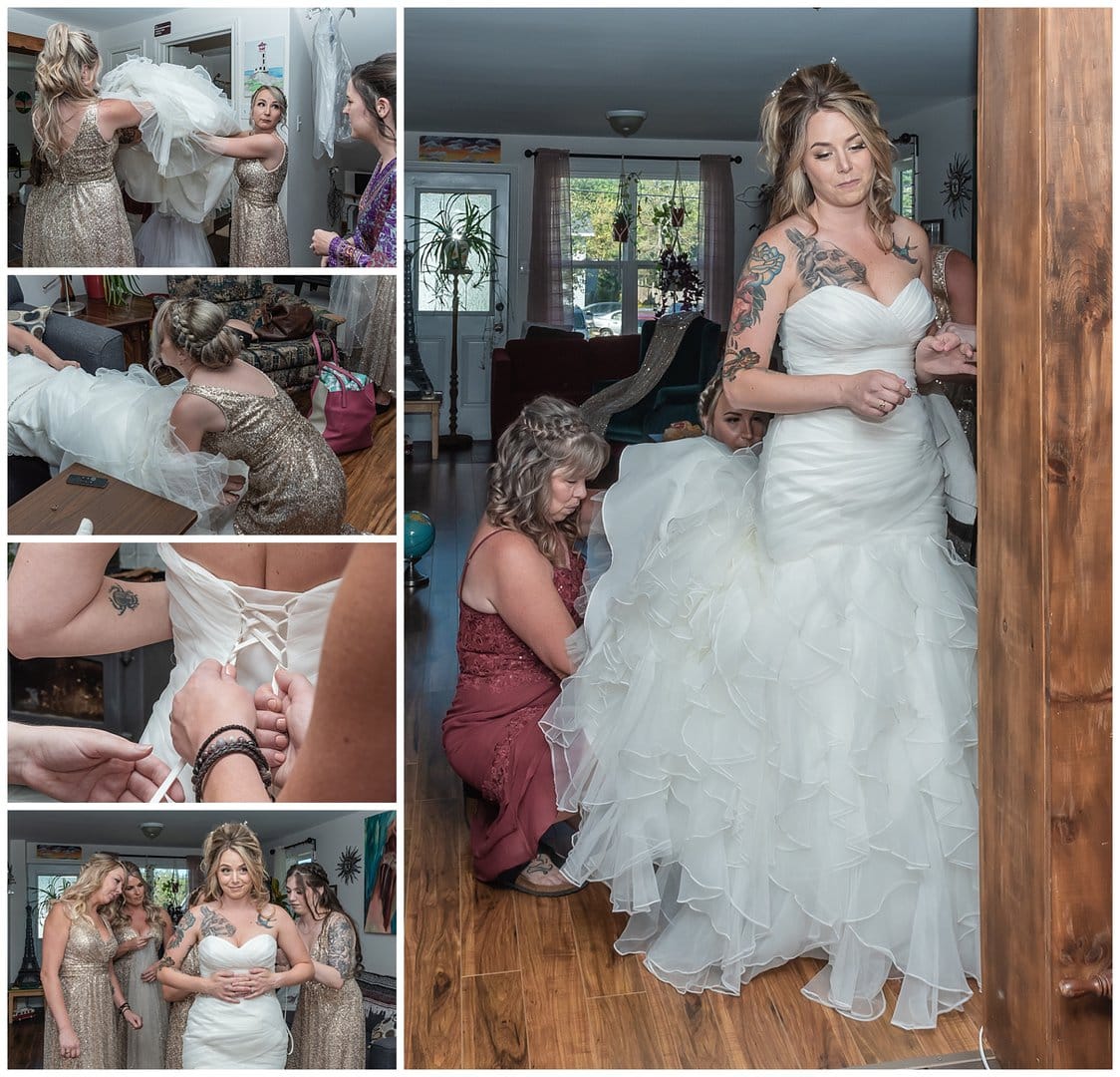The bride gets into her wedding gown during her bridal prep.