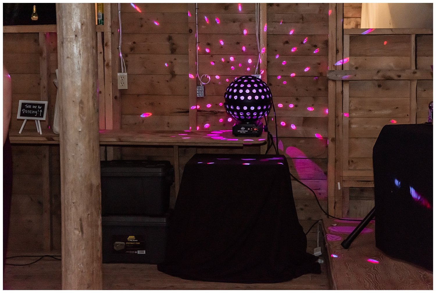 A DJ's globe lit up with purple lights.