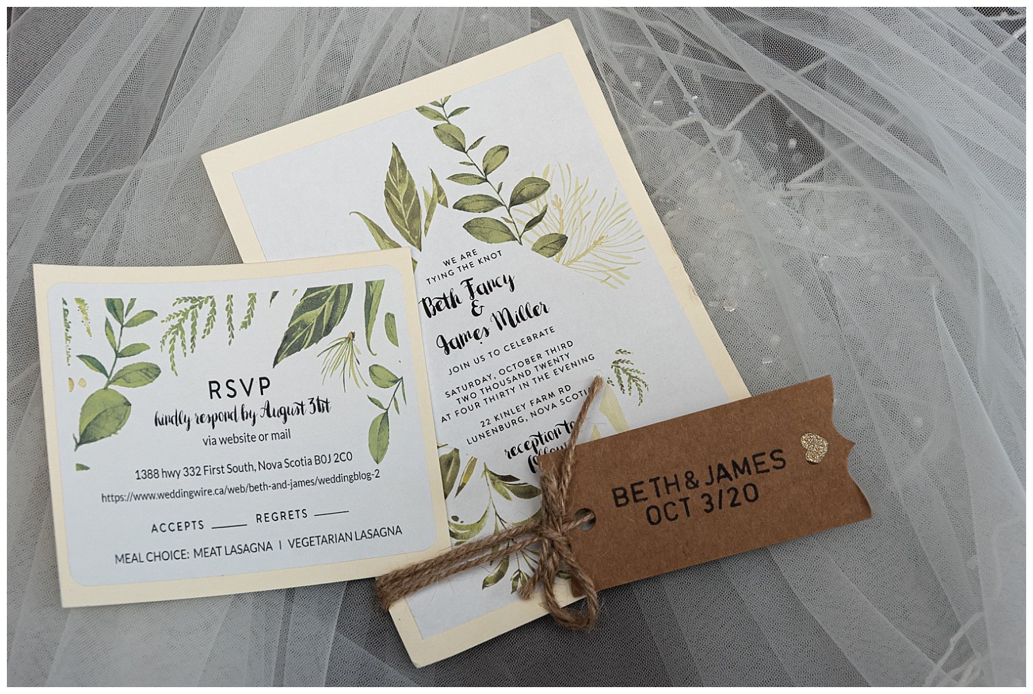 An ivory and brown rustic style wedding invitation with green leaves.