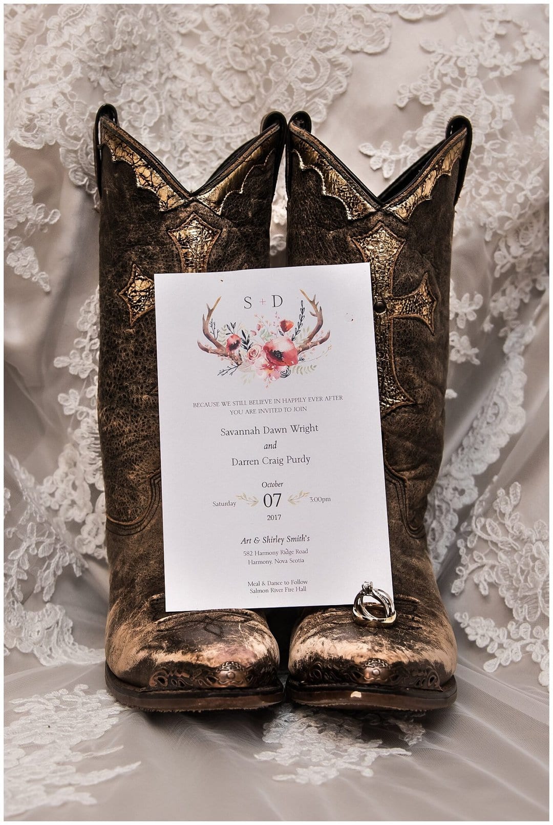 A beautiful rustic wedding invitation adorned with deer antlers.