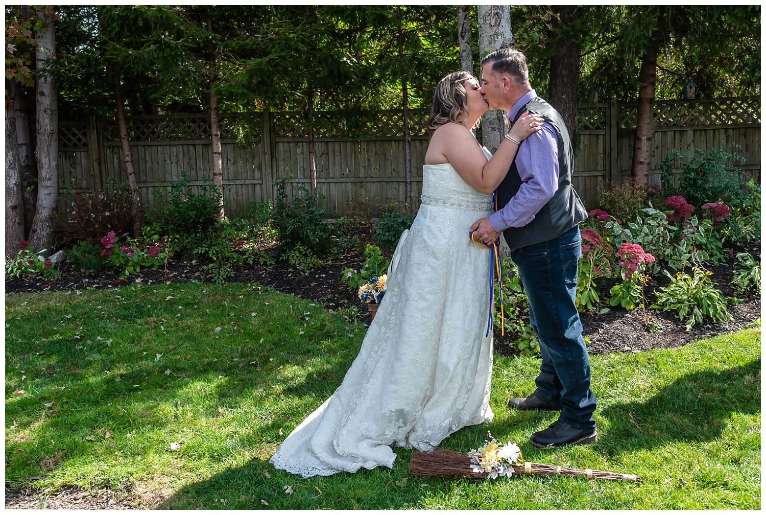 The bride and groom share their first kiss as Mr and Mrs Parsons during their backyard wedding.