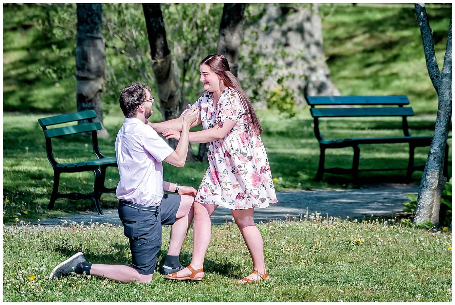 Boyfriend down on one knee asking his girlfriend to marry him.