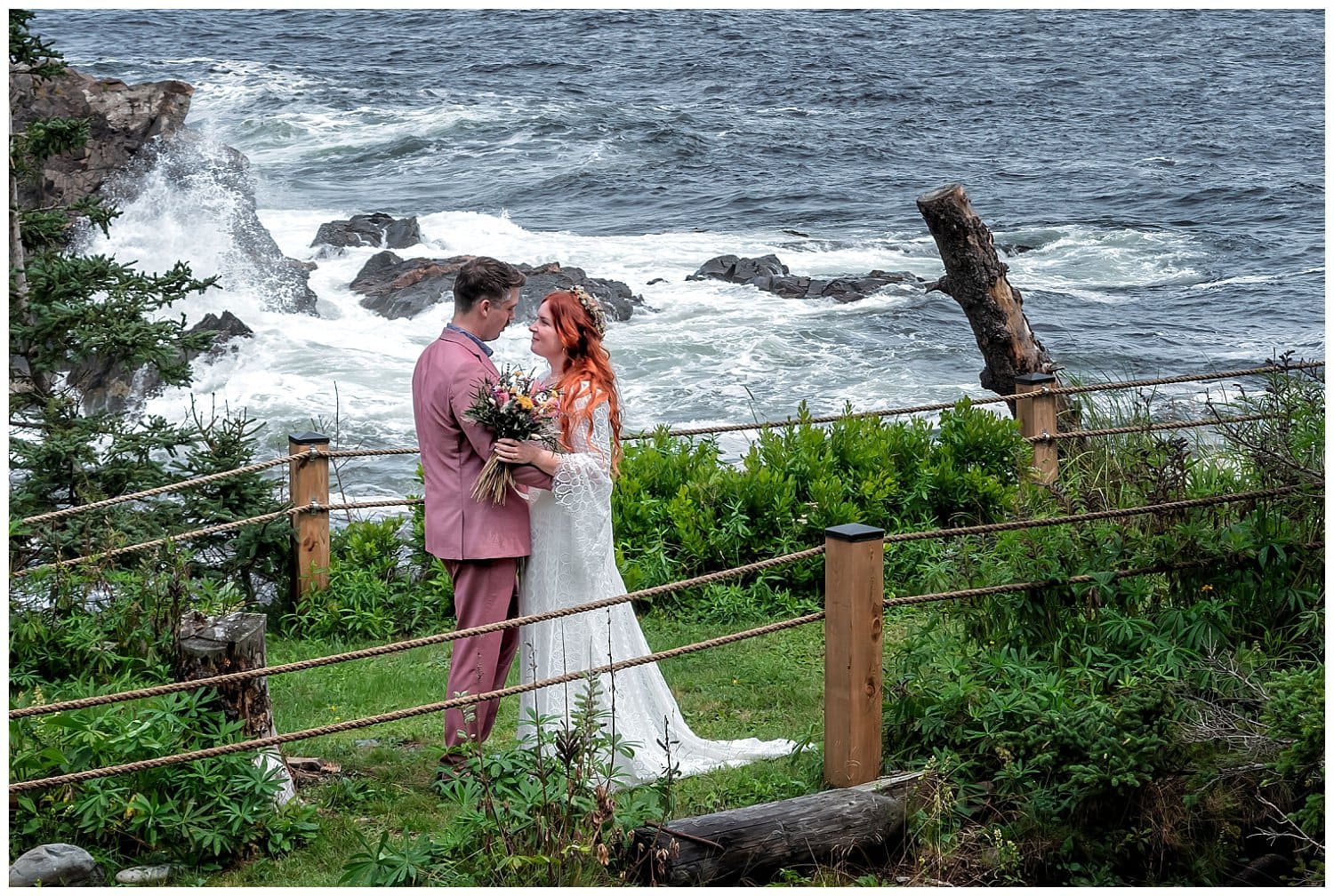 The bride and groom pose for oceanfront wedding photos at an Airbnb in Bear Cove NS.