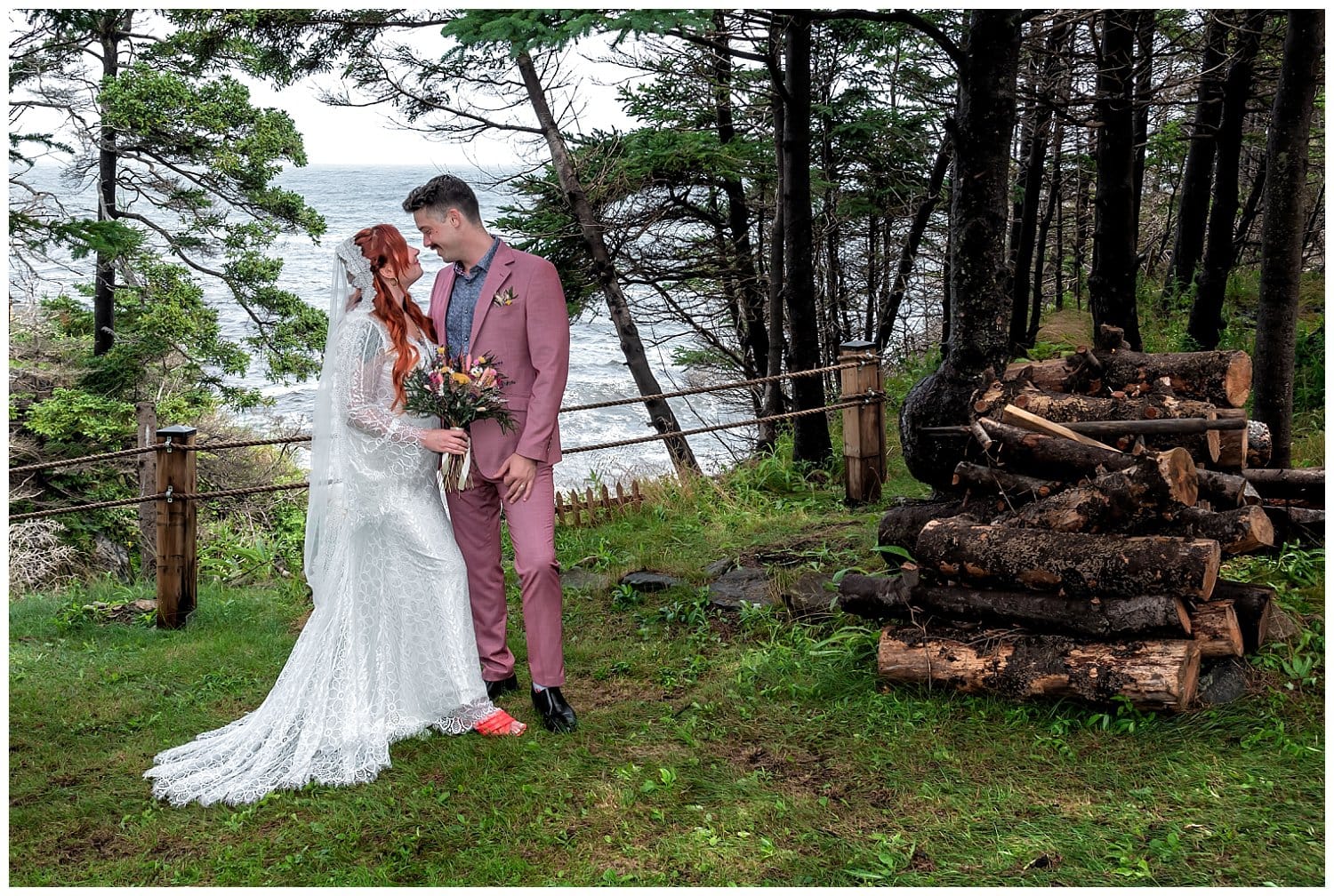 The bride and groom embrace in front of the ocean during their wedding photos at an Airbnb in Bear Cove NS.