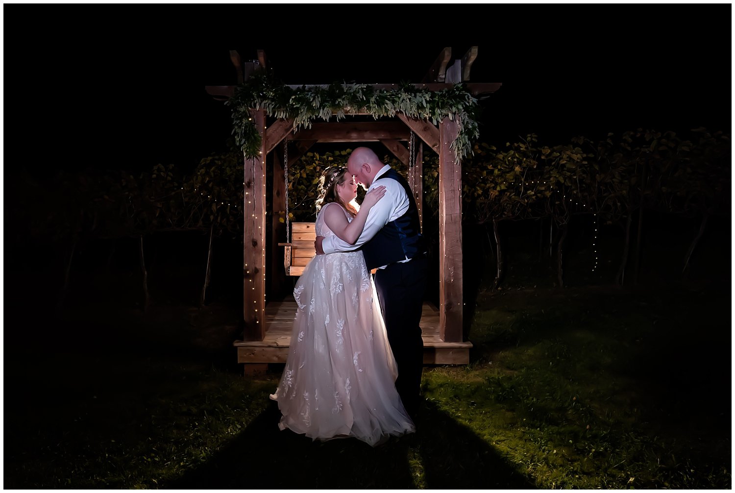 The bride and groom pose during the night for wedding photos at Bent Ridge Winery in NS.