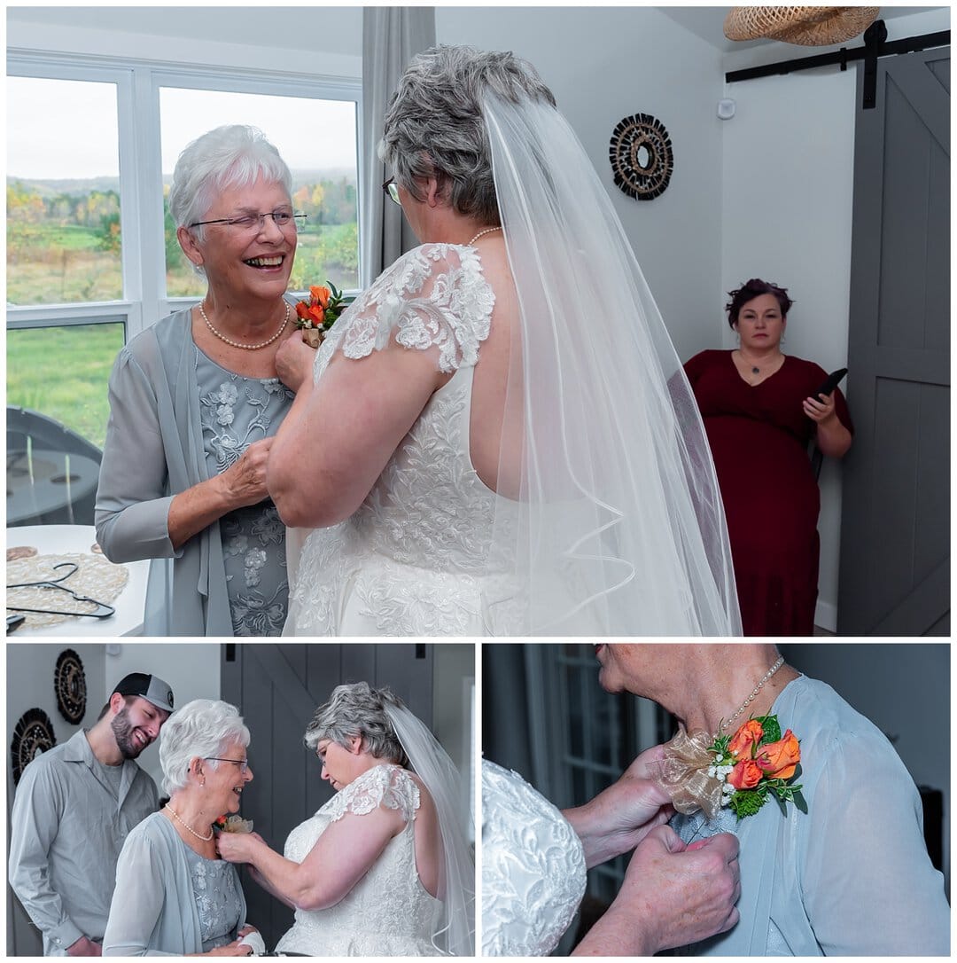 The bride pins the corsage on her mother while getting ready for her big day.