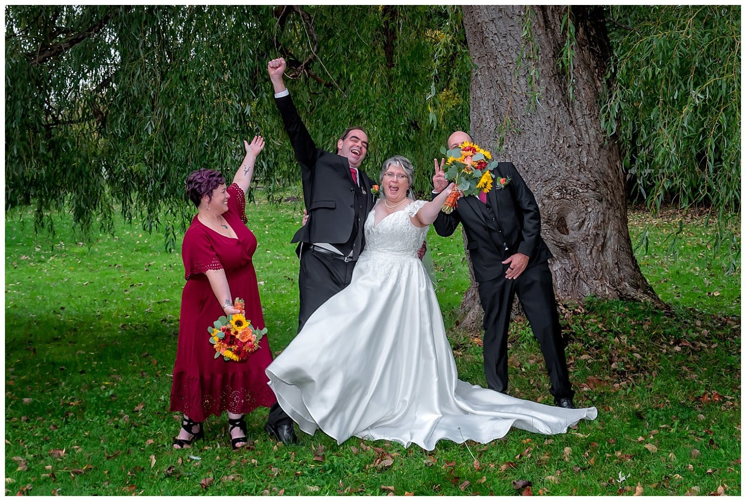 The bride and groom with their wedding party pose for funny photos in Windsor NS.