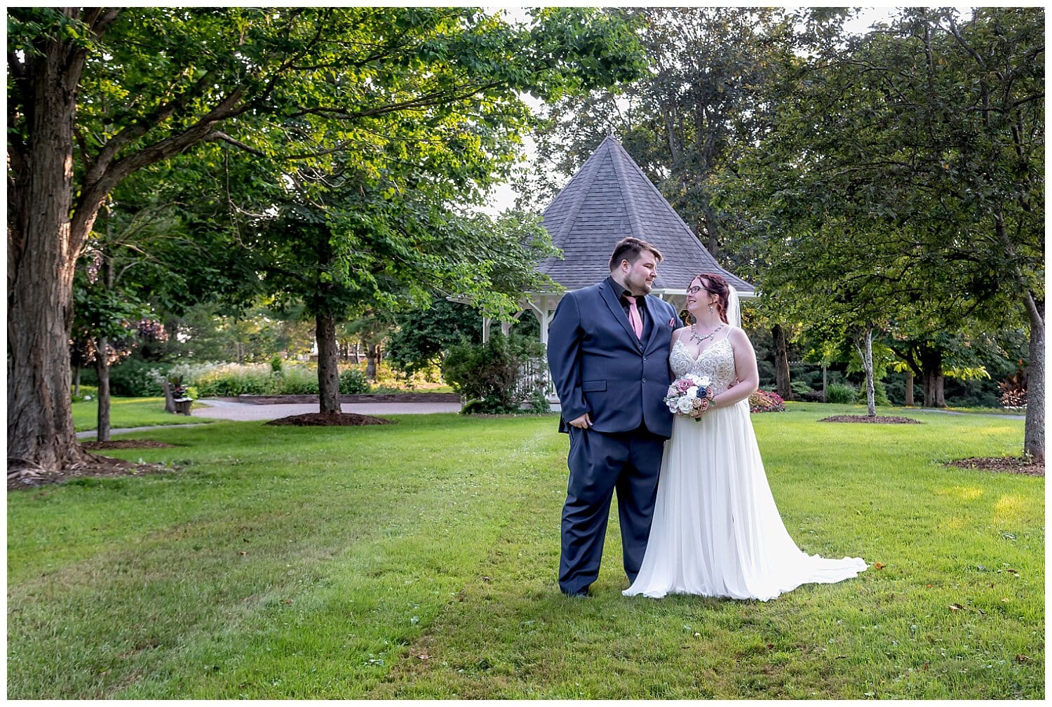 The bride and groom pose for wedding photos in the Alumni Gardens in Truro NS.