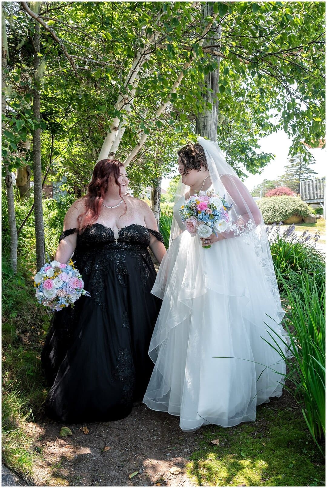 The brides walk in the woods together during their wedding at White Point Beach Resort in NS.