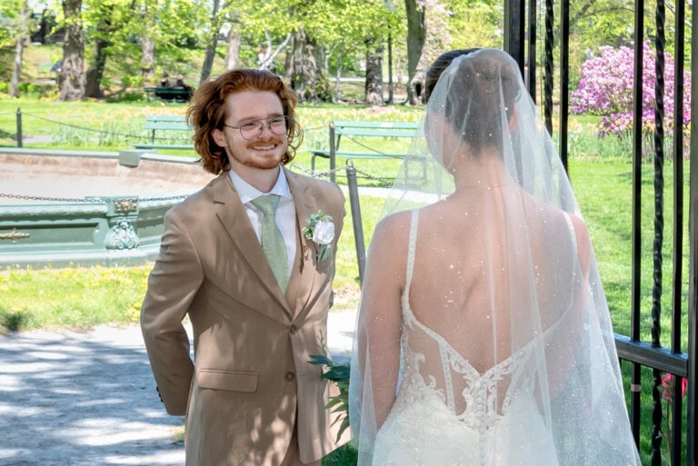 Bride and groom sharing their first look in the Halifax Public Gardens surrounded by spring greenery.