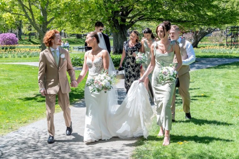 Bride and Groom walking towards their wedding ceremony after their first look at the Halifax Public Gardens.