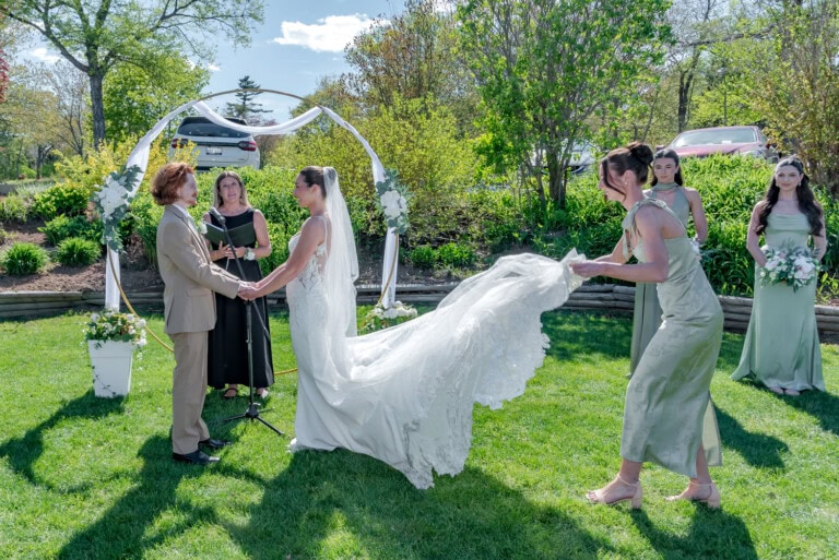 Couple holding hands at the altar while the officiant leads the ceremony at Ashburn Golf Club in Halifax.