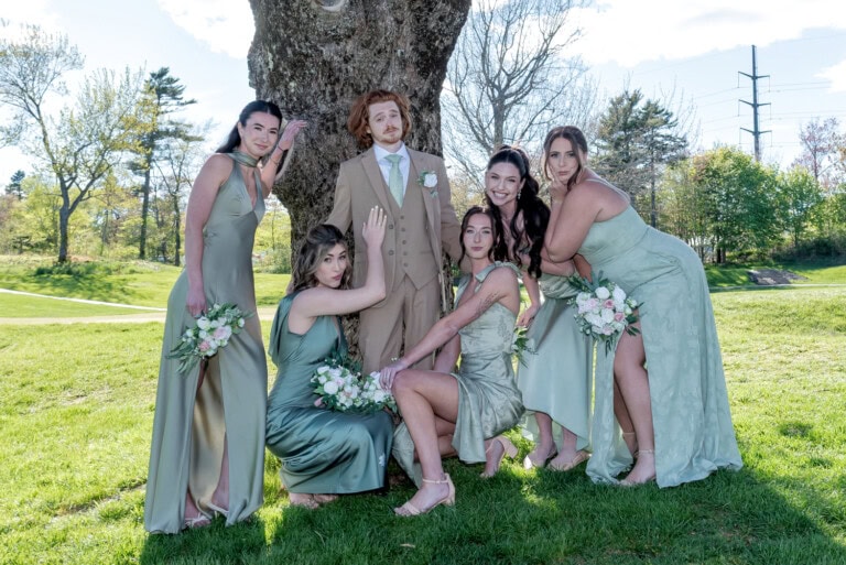 Bridesmaids and groom smiling together during wedding photos at Ashburn Golf Club in Halifax.