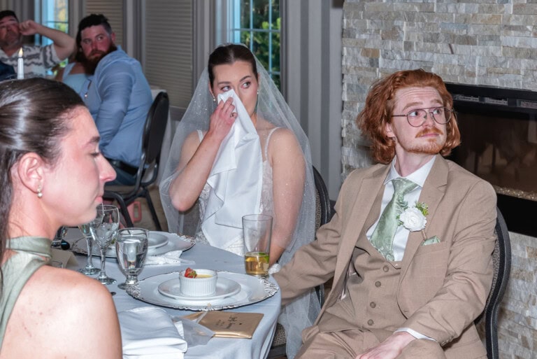 Bride wiping away tears during an emotional wedding reception speech at Ashburn Golf Club in Halifax.