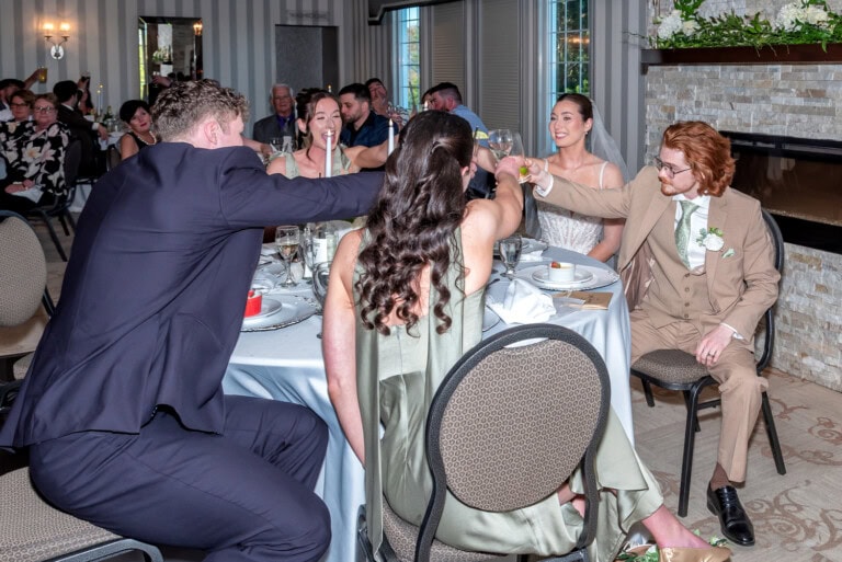 Bride and groom raising glasses during wedding reception speeches at Ashburn Golf Club in Halifax.