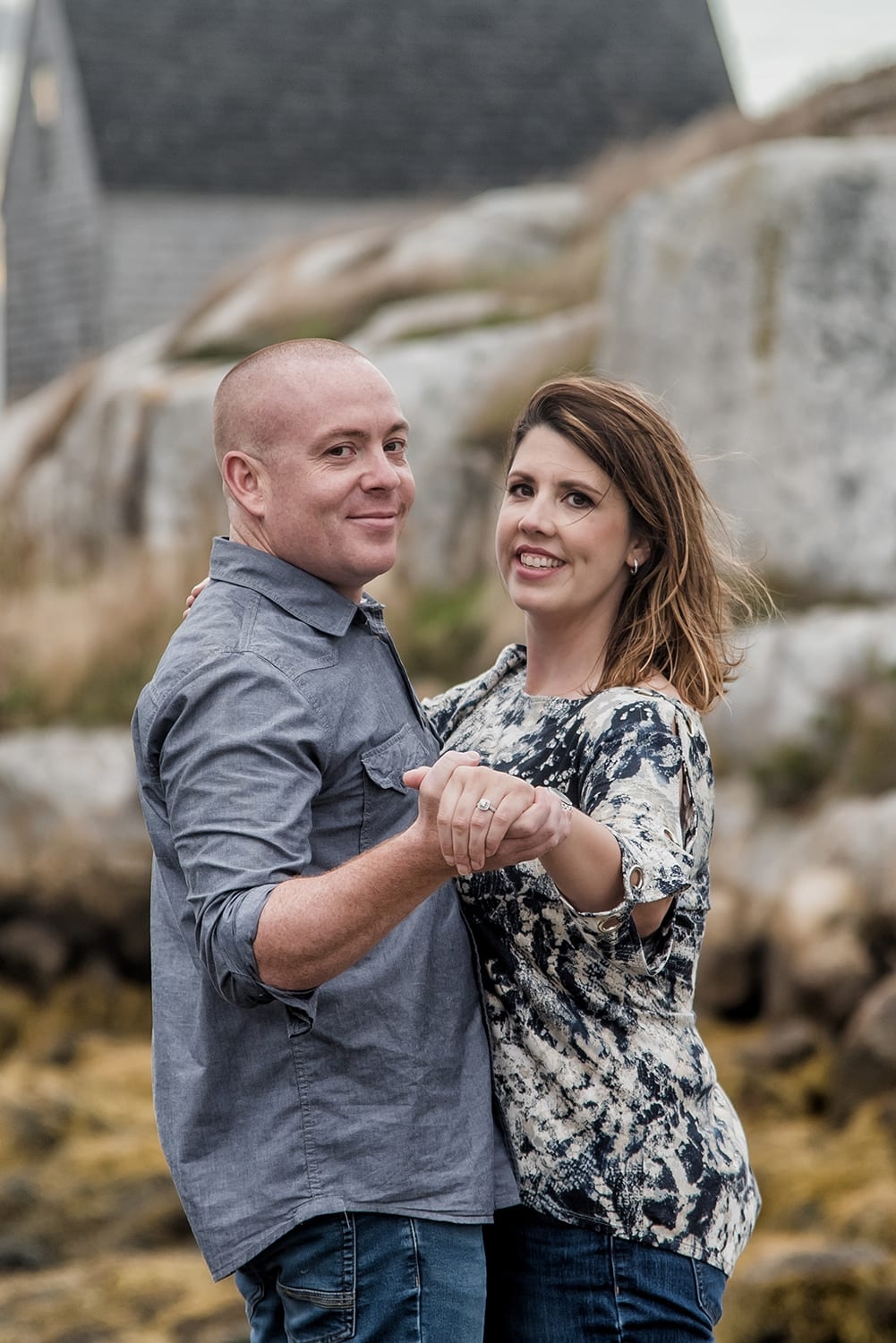 Engagement Portfolio Page A couple in love holding hands, engagement photos at Peggys Cove, NS.