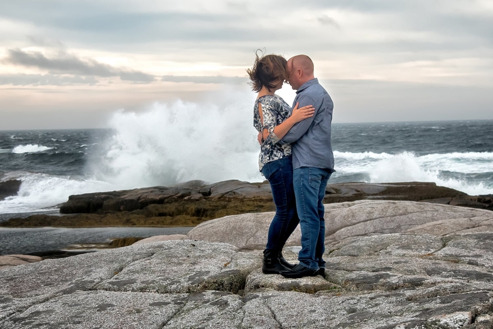 Nathalie & Matt <br> Peggy's Cove, NS A cute couple embracing for their engagement photos at Peggys Cove in Nova Scotia.