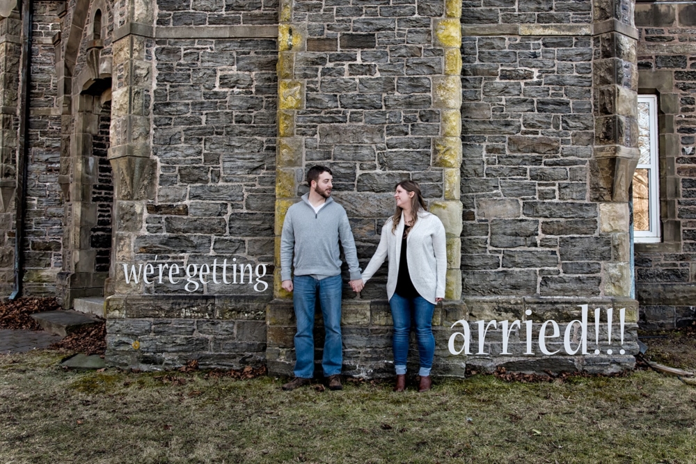 Engagement Portfolio Page A couple hold hands against the gatehouse in Point Pleasant Park in Halifax, NS.