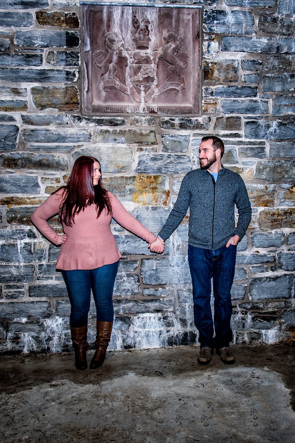Engagement Portfolio Page A couple holds hands during engagement photos at the Dingle Tower in Halifax, NS.