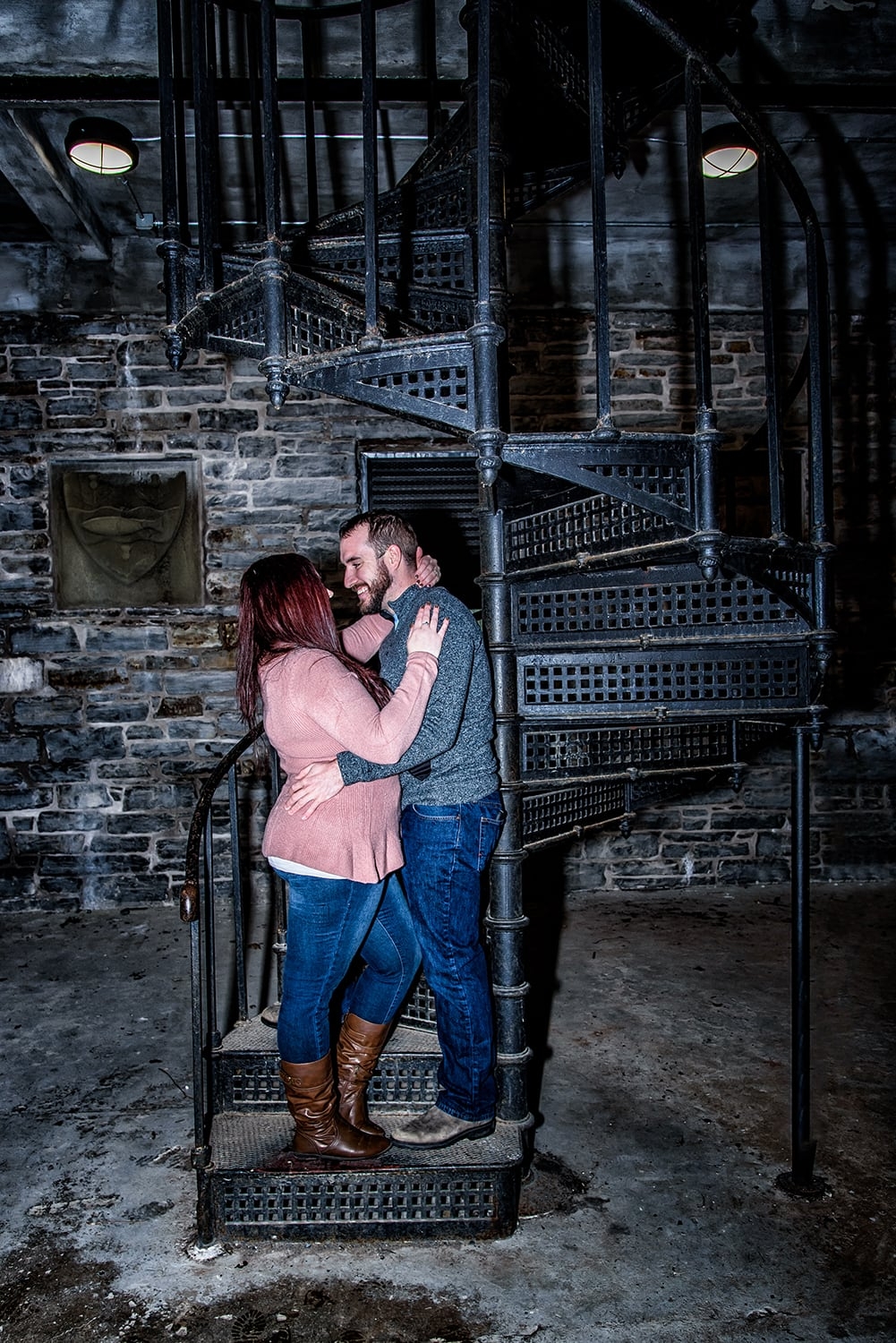Engagement Portfolio Page A couple in an embrace during engagement photos inside the Dingle Tower in Halifax,, NS.