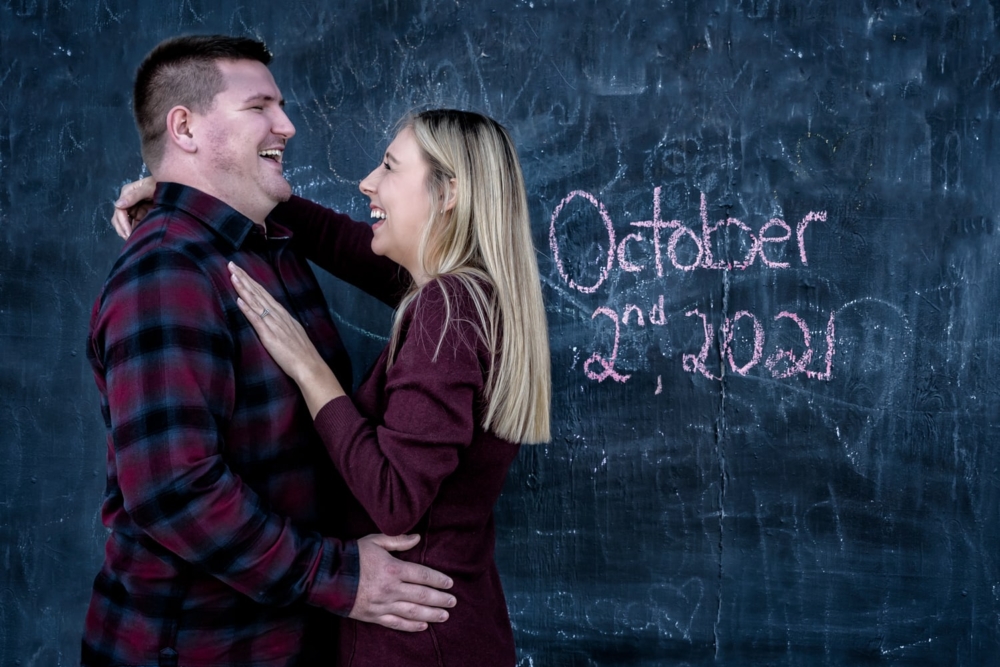 The bride and groom to be pose for engagement photos at the Historic Properties in Halifax, NS.