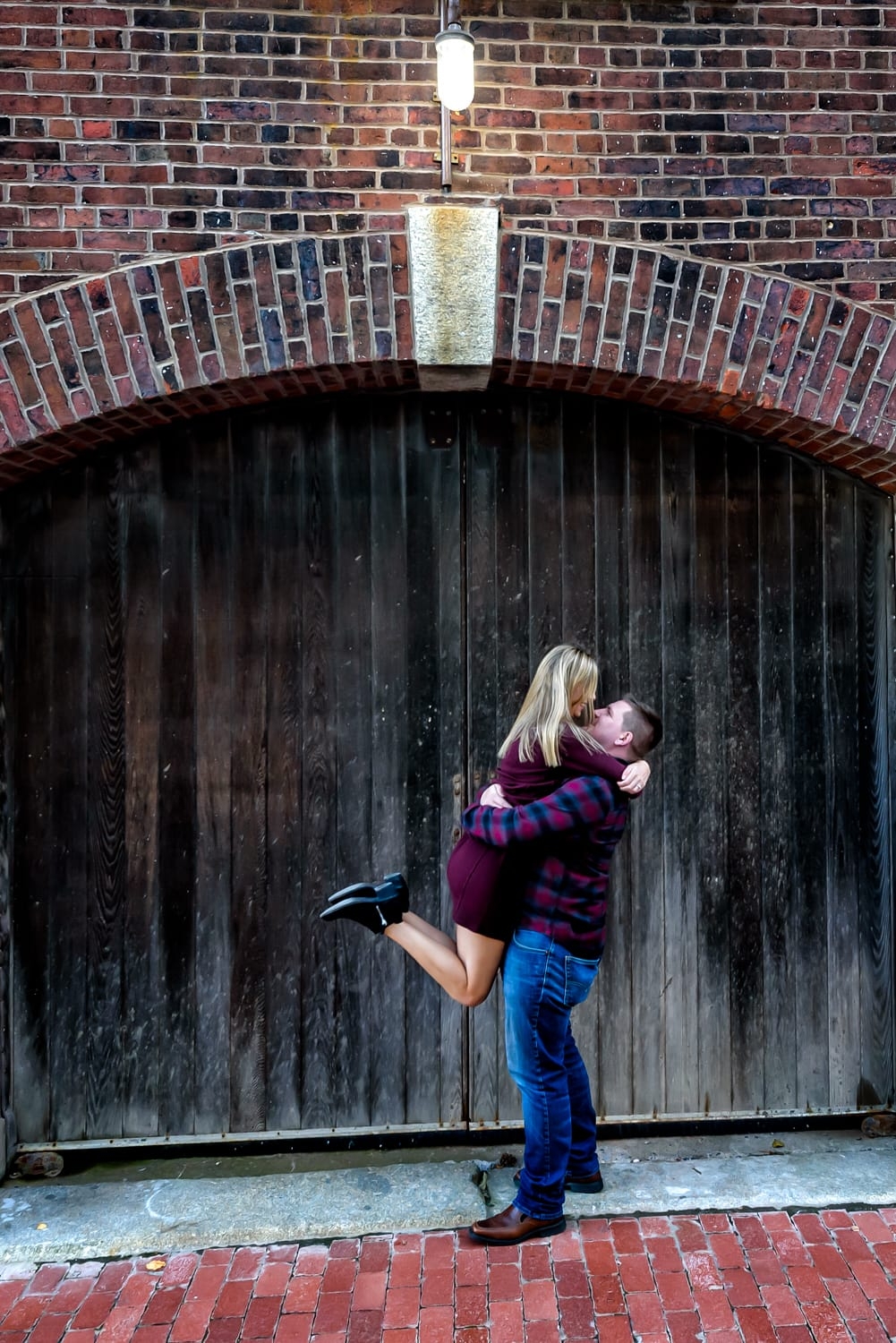 Future bride and groom pose for engagement photos in the urban area of the Halifax Waterfront.