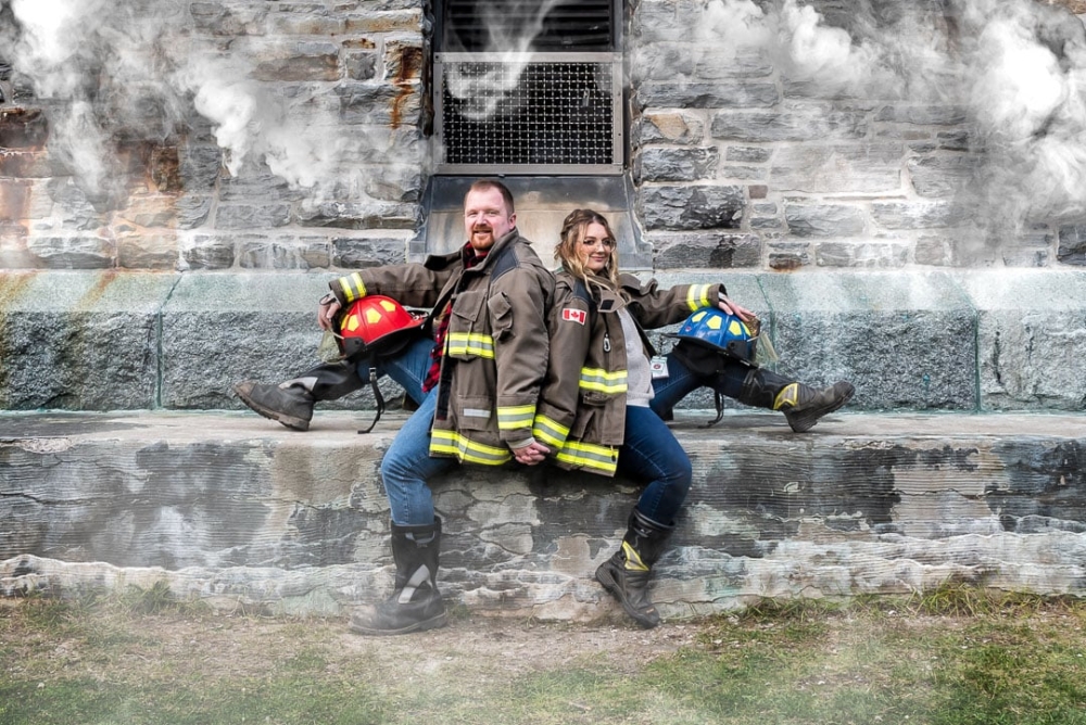 Soon to be bride and groom pose for their firefighter engagement photos at the Dingle Tower in Halifax, NS.